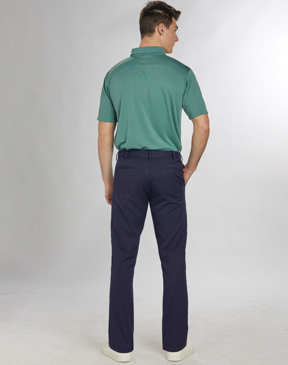a man in a green shirt and blue pants