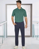 a man in a green shirt and blue pants